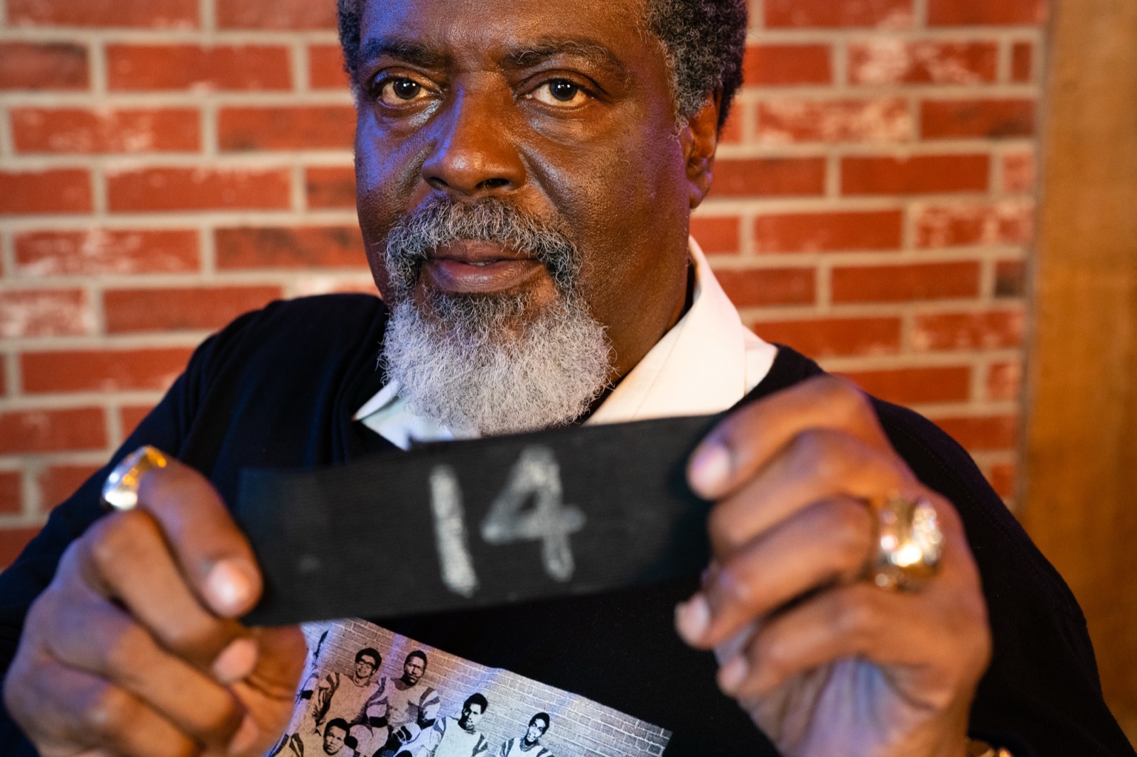 A member holding the number 14 armband.