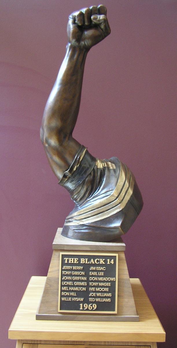 The Black 14 trophy — a raised fist engraved with all fourteen names and the year 1969.
